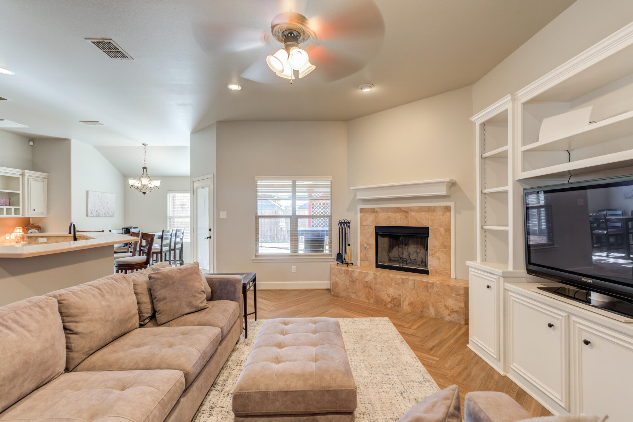4707 106th Street Lubbock, TX 79424 - Photo 6 of 51 a living room with furniture a flat screen tv and a fireplace