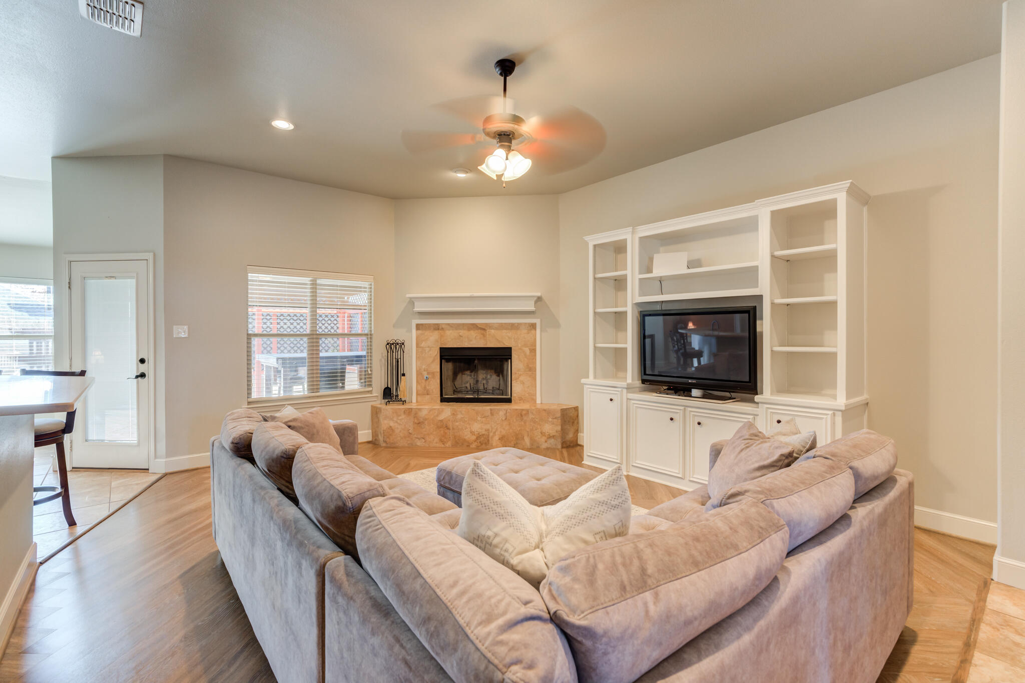 4707 106th Street Lubbock, TX 79424 - Photo 8 of 51 a living room with furniture a flat screen tv and a fireplace