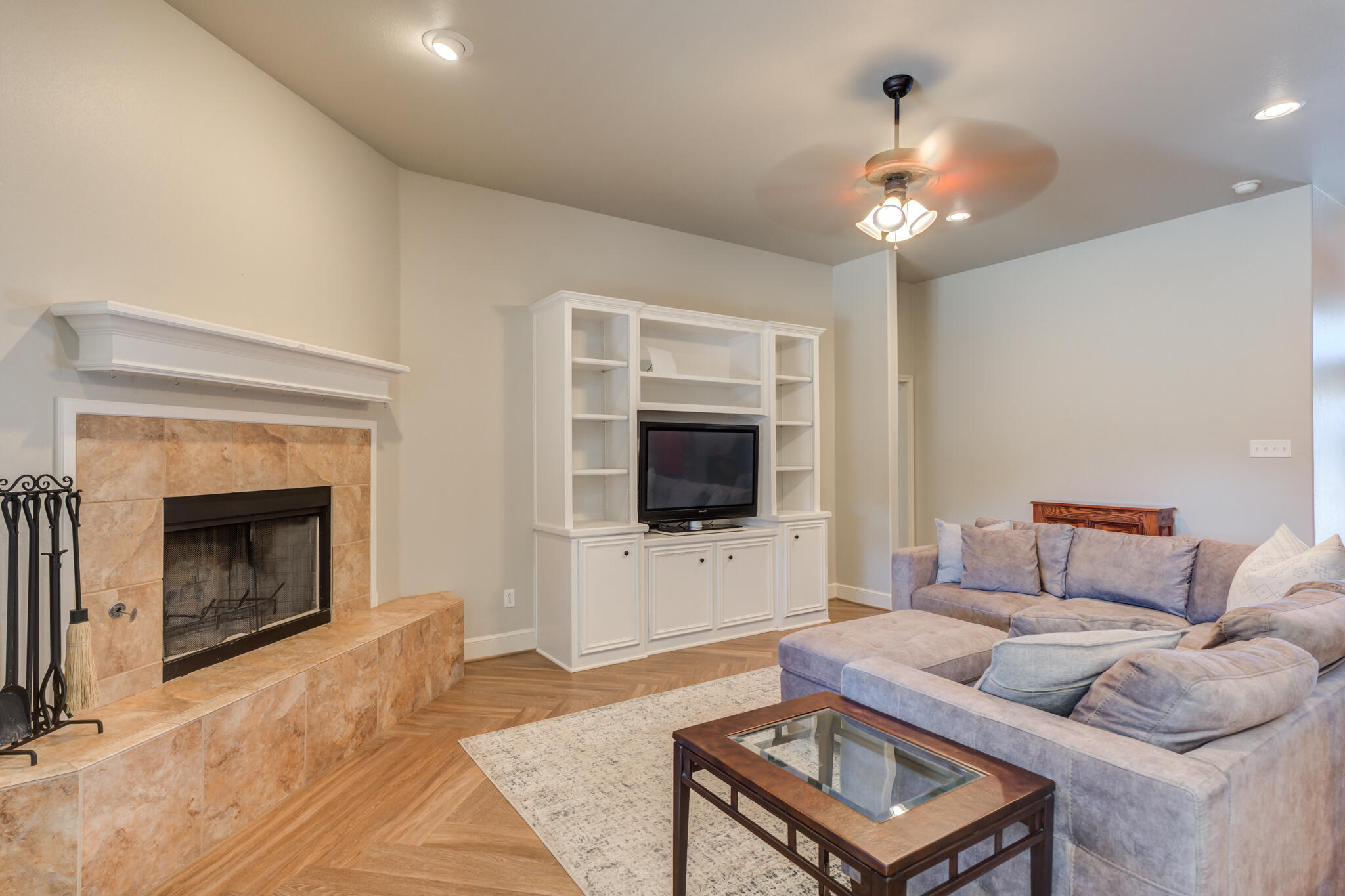 4707 106th Street Lubbock, TX 79424 - Photo 9 of 51 a living room with furniture a flat screen tv and a fireplace