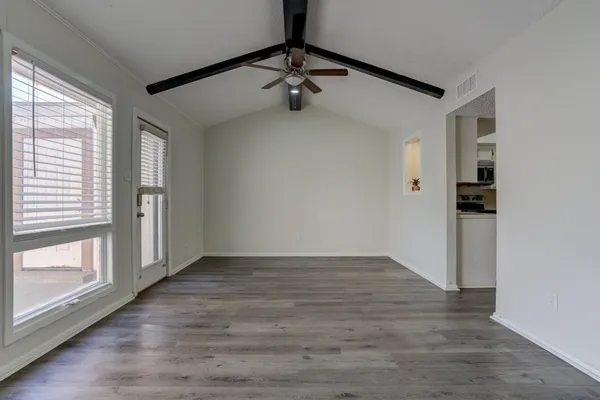a view of an empty room with glass door