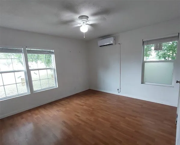 an empty room with windows and entrance