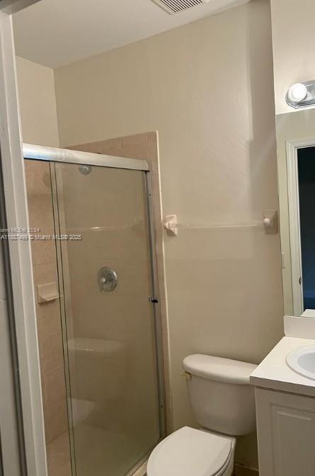 205 Southeast 29th Terrace, Unit 5 Homestead, FL 33033 - Photo 12 of 17 a white toilet sitting next to a bathroom sink