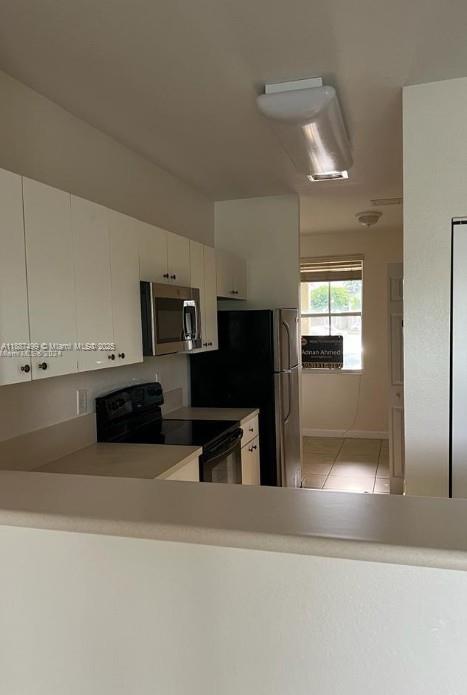 205 Southeast 29th Terrace, Unit 5 Homestead, FL 33033 - Photo 3 of 17 a kitchen with stainless steel appliances granite countertop a refrigerator and a stove