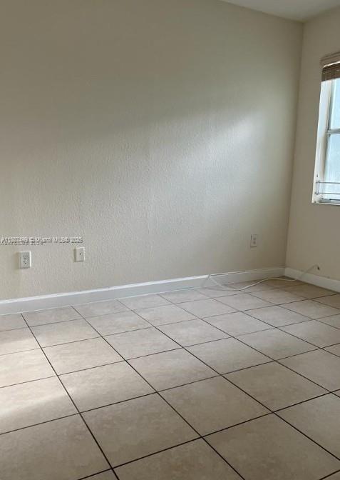 205 Southeast 29th Terrace, Unit 5 Homestead, FL 33033 - Photo 9 of 17 en empty room with windows