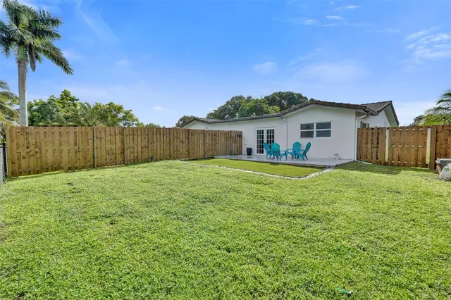 a view of a backyard with sitting area