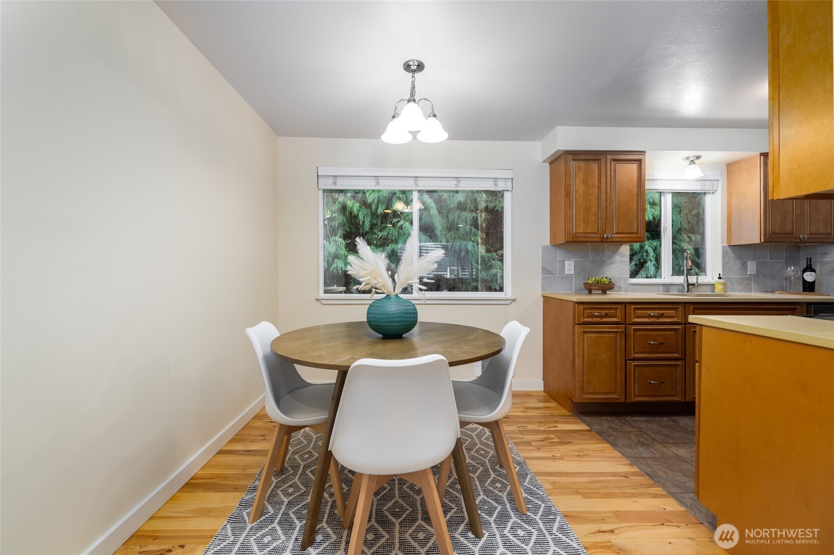 611 Whatcom Street La Conner, WA 98257 - Photo 11 of 26 a kitchen with a table chairs a sink and dishwasher