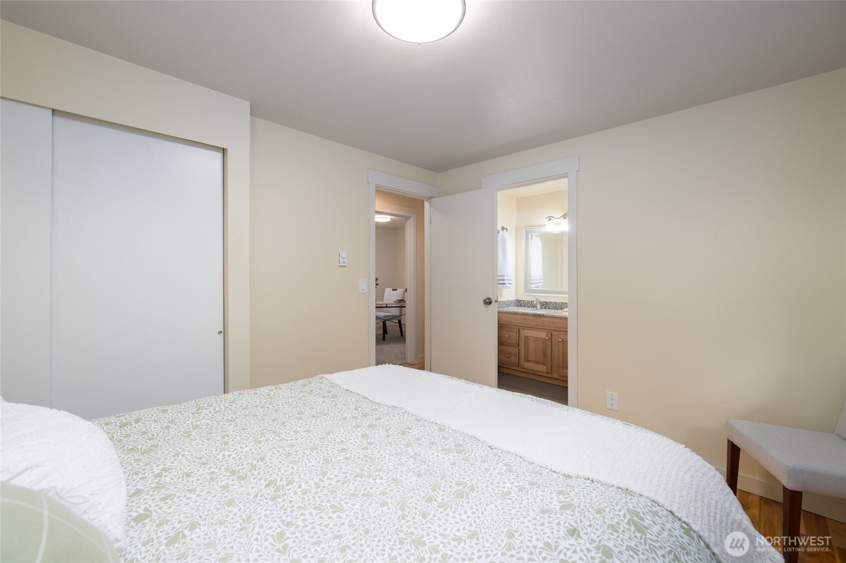 611 Whatcom Street La Conner, WA 98257 - Photo 16 of 26 a bedroom with a bed and a chandelier