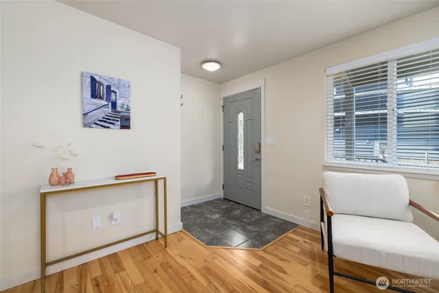a view of a livingroom with wooden floor and furniture