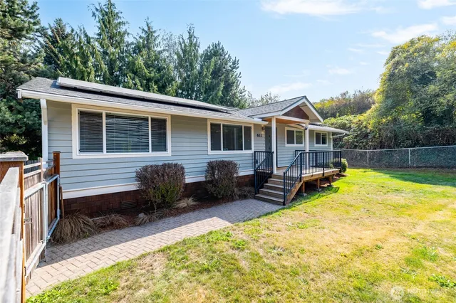 a view of a house with a yard and furniture