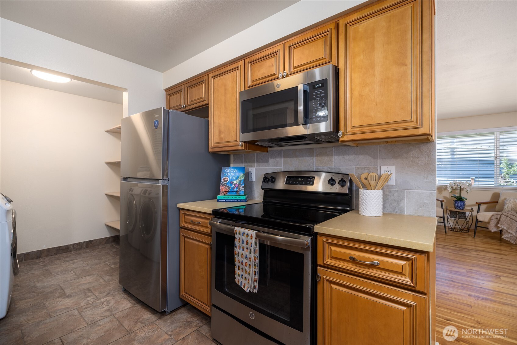 611 Whatcom Street La Conner, WA 98257 - Photo 5 of 26 a kitchen with stainless steel appliances granite countertop a refrigerator stove and microwave