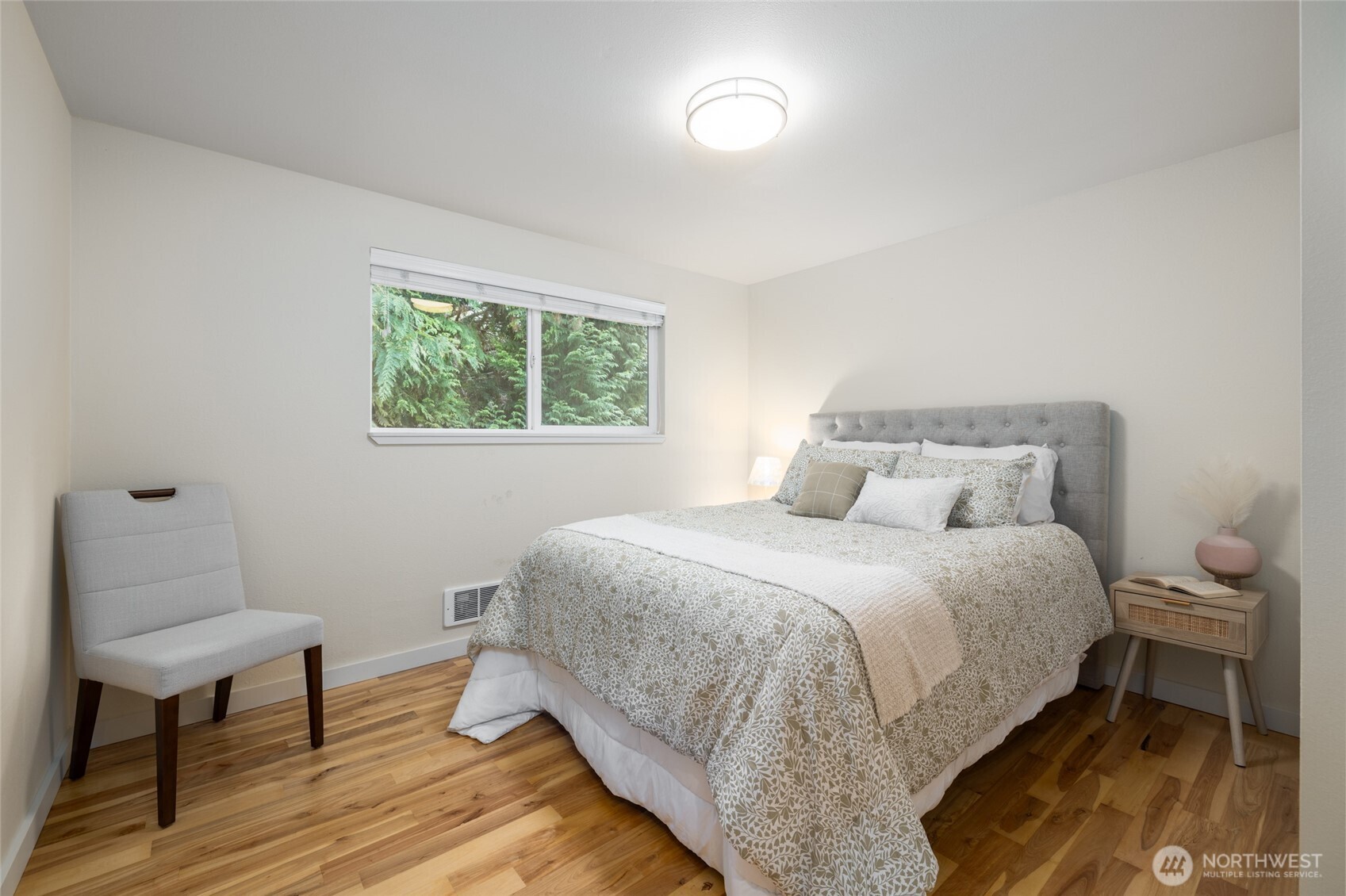 611 Whatcom Street La Conner, WA 98257 - Photo 8 of 26 a bedroom with a bed and a chair