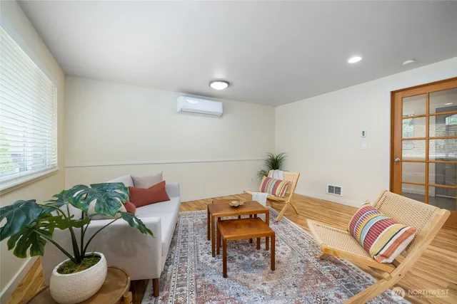 a living room with furniture and a potted plant
