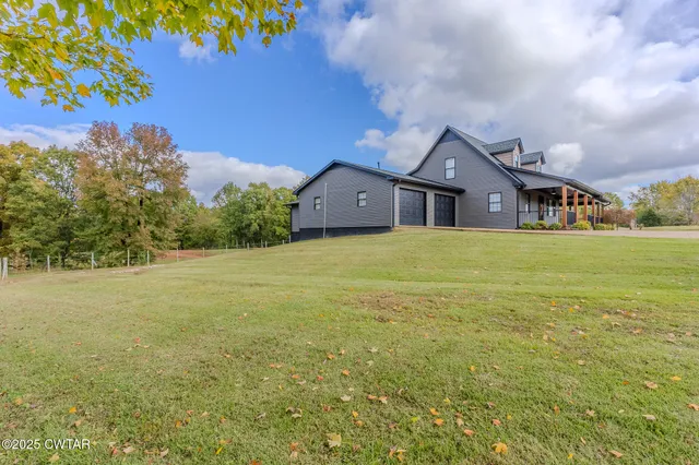 a front view of a house with a big yard