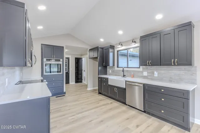 a kitchen with a sink and wooden cabinets