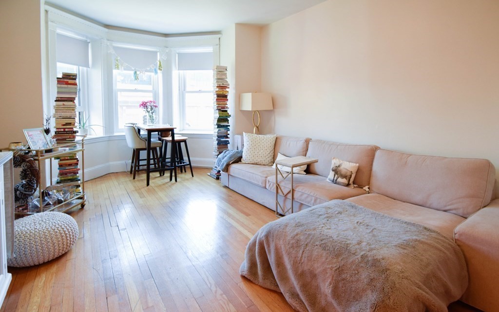 8 Garrison Street, Unit 409 Boston, MA 02116 - Photo 2 of 9 a living room with furniture and a wooden floor