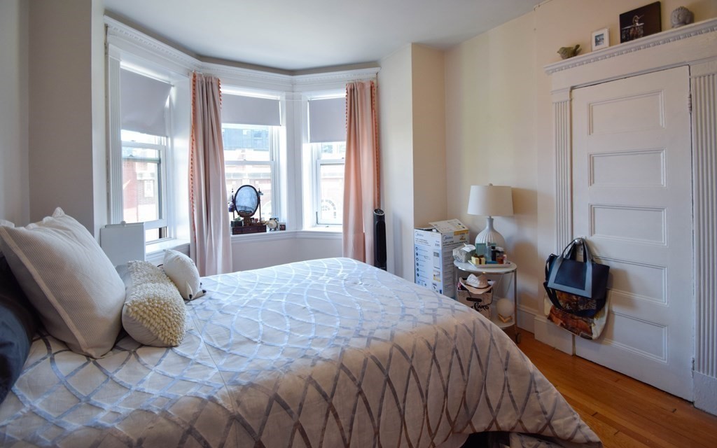 8 Garrison Street, Unit 409 Boston, MA 02116 - Photo 5 of 9 a bedroom with a bed and large windows