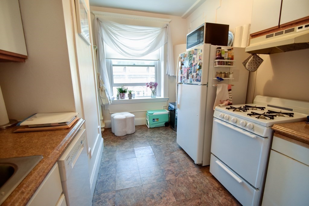 8 Garrison Street, Unit 409 Boston, MA 02116 - Photo 6 of 9 a kitchen with a refrigerator and a stove