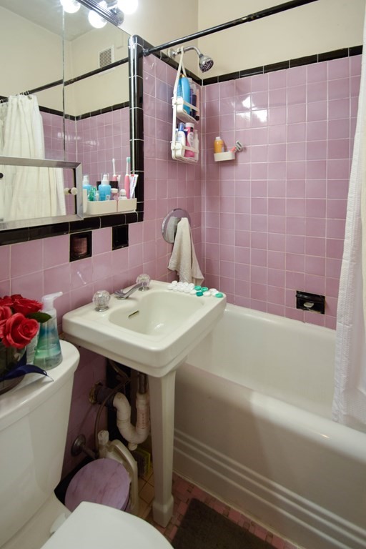 8 Garrison Street, Unit 409 Boston, MA 02116 - Photo 9 of 9 a bathroom with a sink and mirror with bathtub