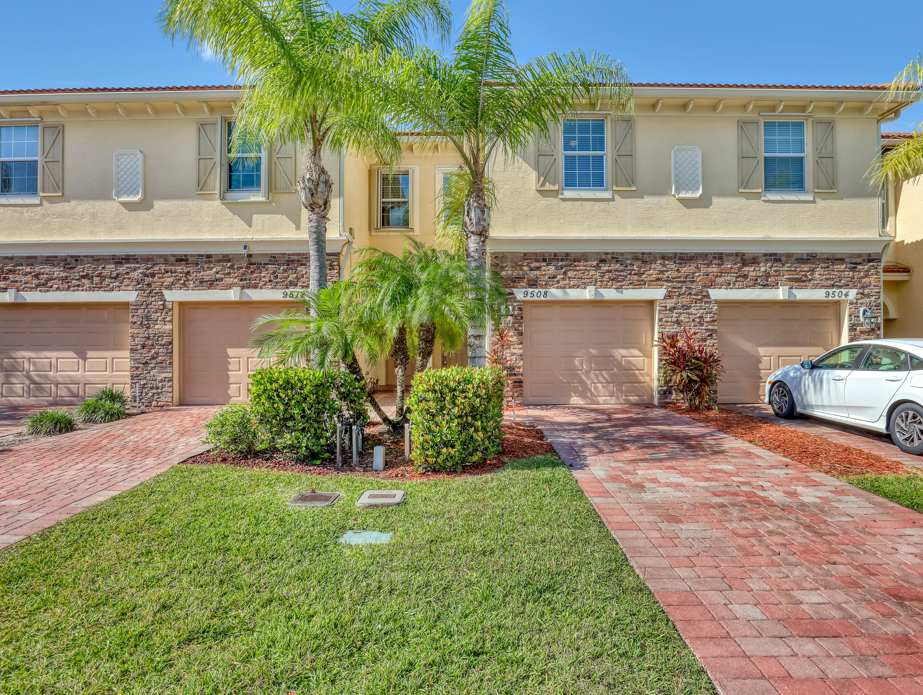 9508 Southwest Otter Lane Stuart, FL 34997 - Photo 1 of 34 a front view of a house with a garden and yard