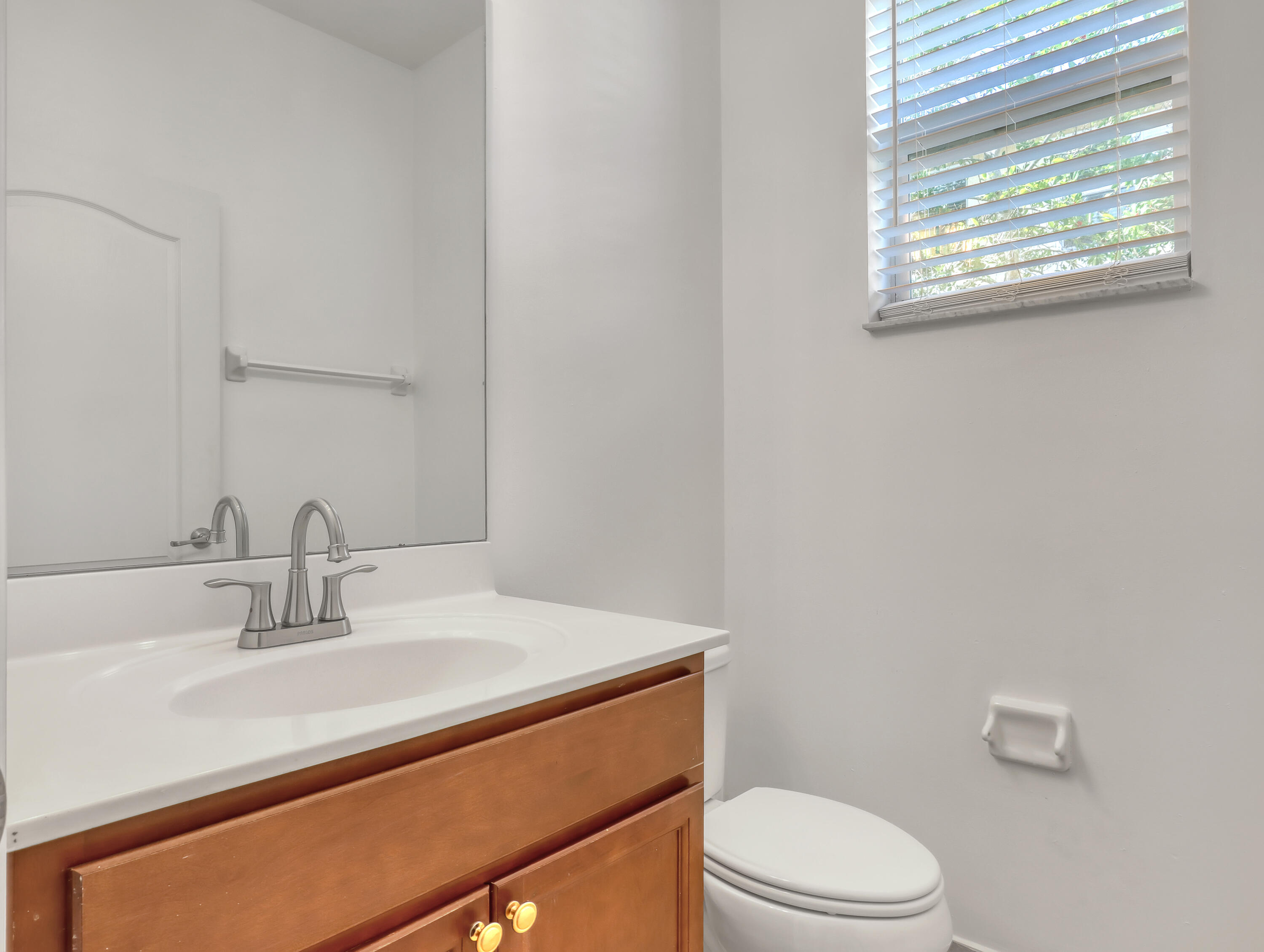 9508 Southwest Otter Lane Stuart, FL 34997 - Photo 17 of 34 a bathroom with a sink a toilet and with mirror