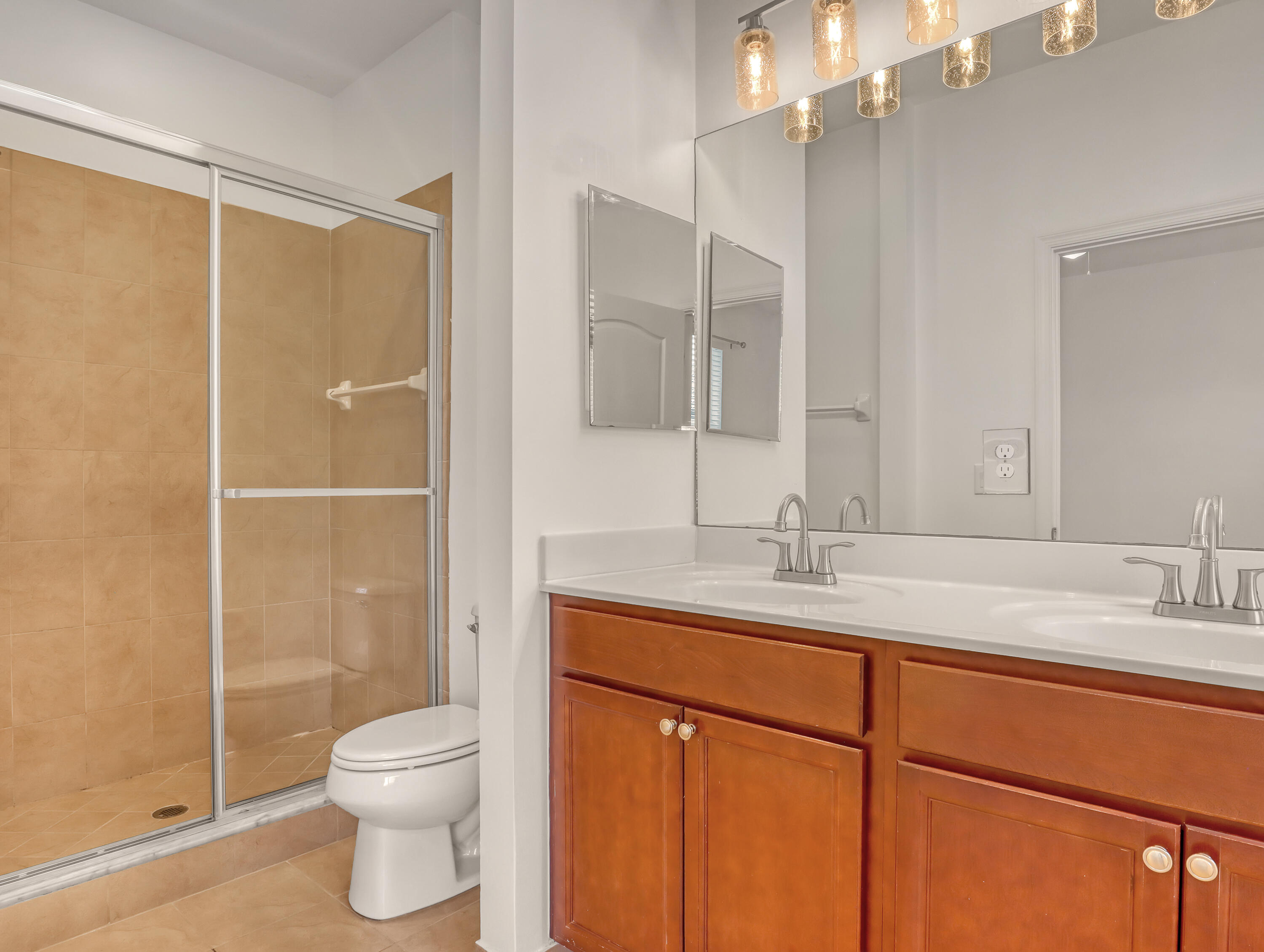 9508 Southwest Otter Lane Stuart, FL 34997 - Photo 23 of 34 a bathroom with a granite countertop sink toilet and shower