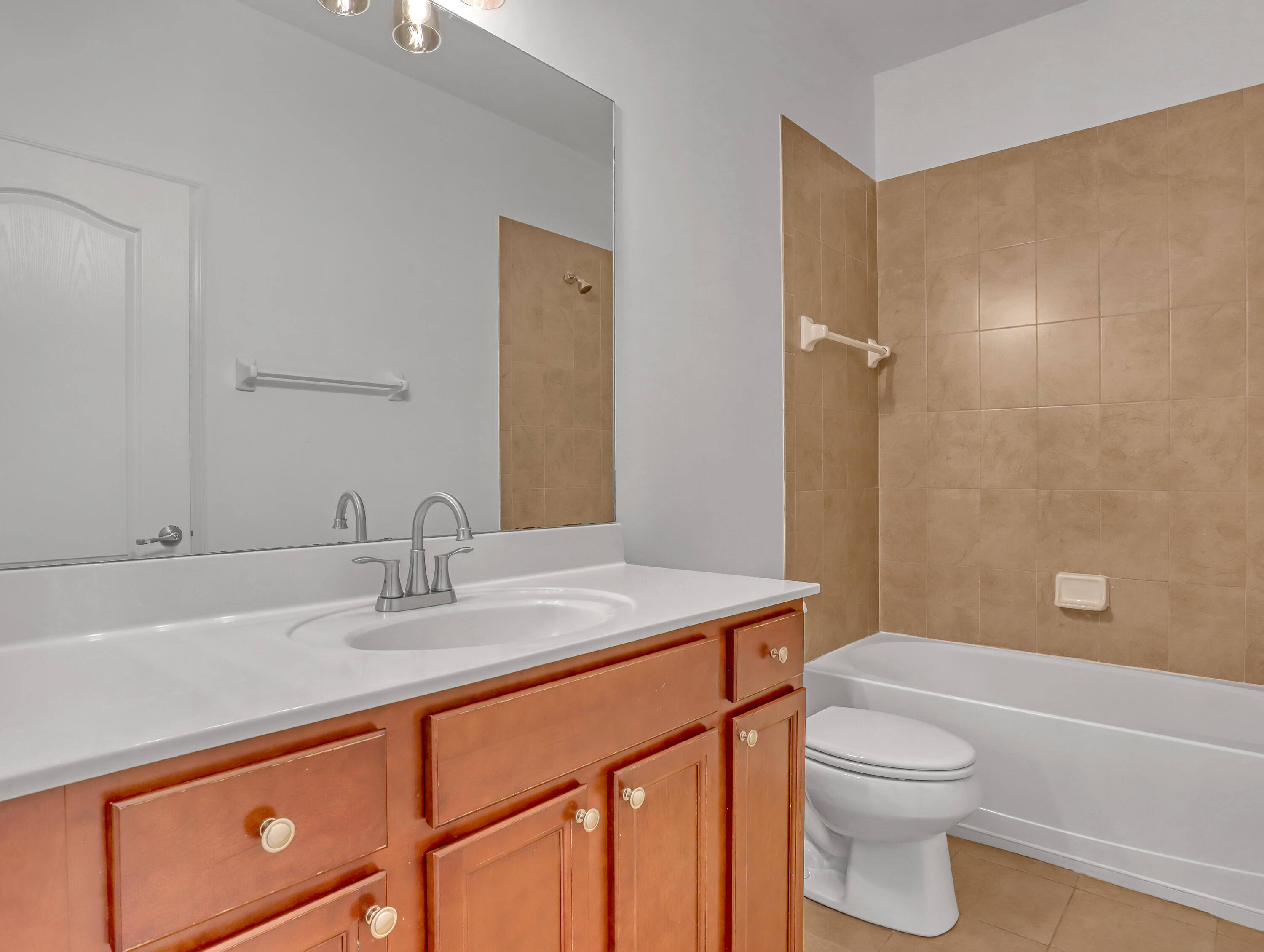 9508 Southwest Otter Lane Stuart, FL 34997 - Photo 27 of 34 a bathroom with a sink a toilet and shower