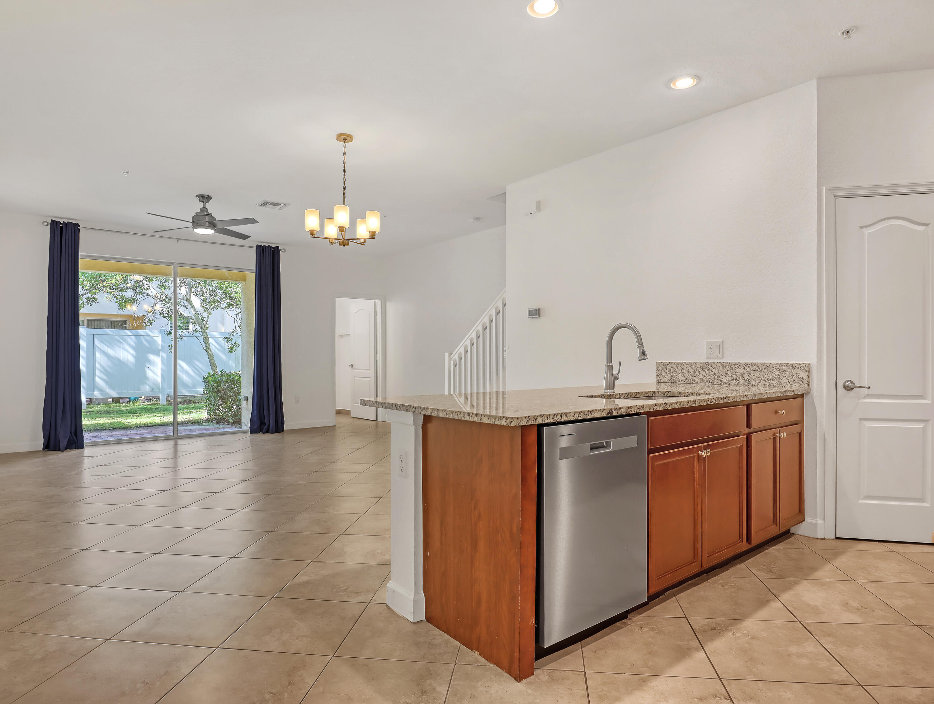 9508 Southwest Otter Lane Stuart, FL 34997 - Photo 6 of 34 a kitchen with stainless steel appliances granite countertop a sink and a stove