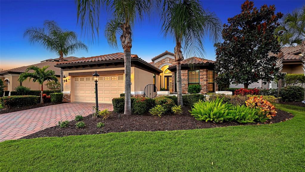 14725 Newtonmore Lane Lakewood Ranch, FL 34202 - Photo 1 of 1 a front view of a house with garden
