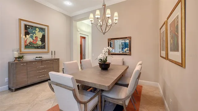 a kitchen with a dining table chairs sink and stove