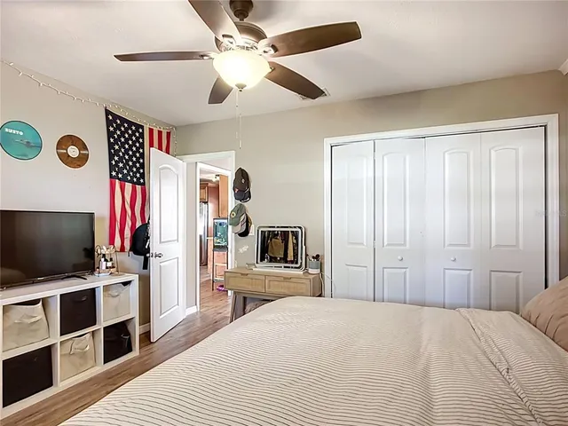 a bedroom with a bed and a flat screen tv