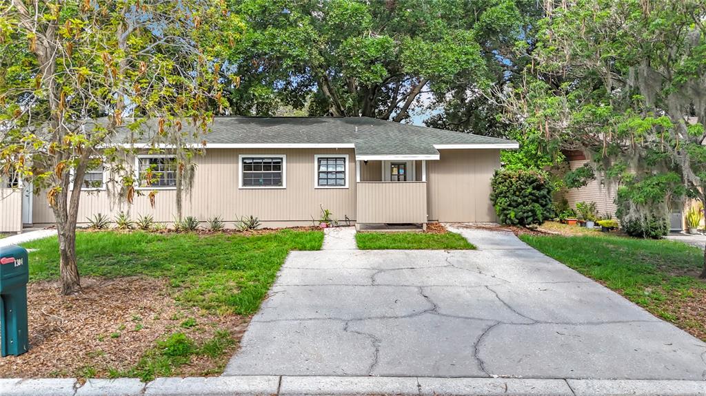1304 Alfred Street, Unit B Brandon, FL 33510 - Photo 2 of 26 front view of house with yard and trees all around