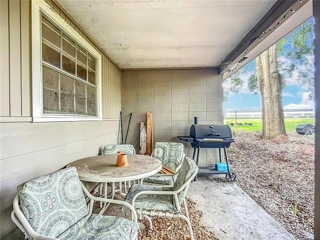 a view of a house with backyard sitting area and garden