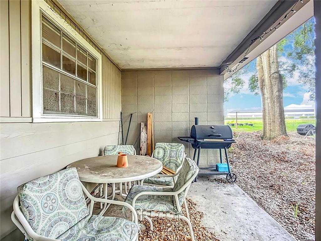 1304 Alfred Street, Unit B Brandon, FL 33510 - Photo 21 of 26 a dining room with furniture a rug and a large window