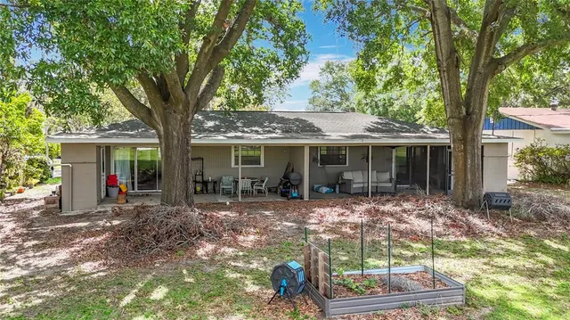 a view of a house with a yard and sitting area