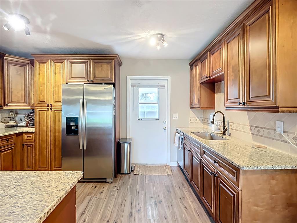 1304 Alfred Street, Unit B Brandon, FL 33510 - Photo 7 of 26 a kitchen with stainless steel appliances granite countertop a sink stove and refrigerator