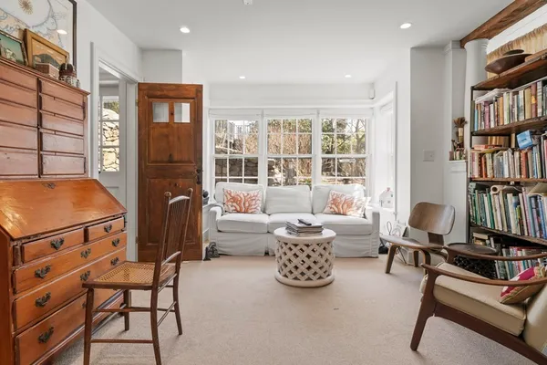 a living room with furniture a bookshelf and a book shelf