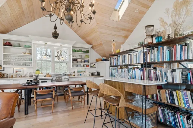 a room with lots of furniture and a book shelf