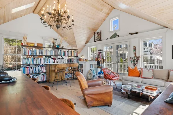 a reading room with furniture book shelf and wooden floor