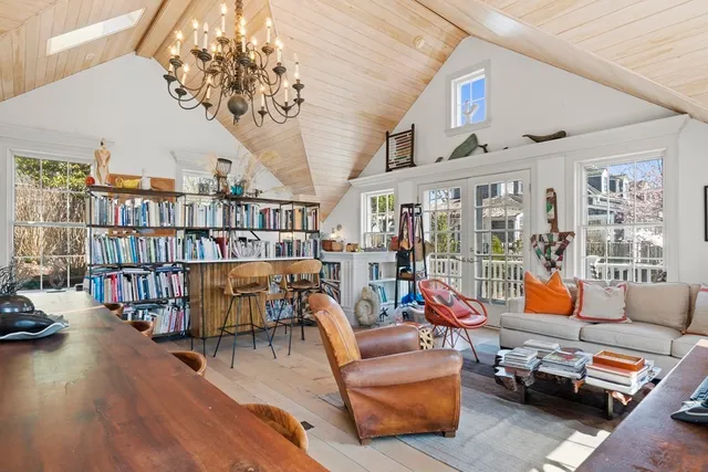 a reading room with furniture book shelf and wooden floor
