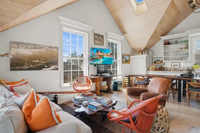 a living room with furniture a rug and a large window