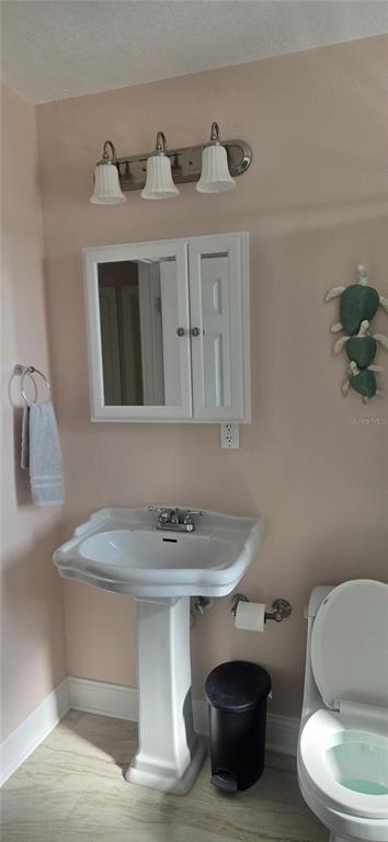 538 Crystal Drive Madeira Beach, FL 33708 - Photo 11 of 21 a bathroom with a sink and a toilet