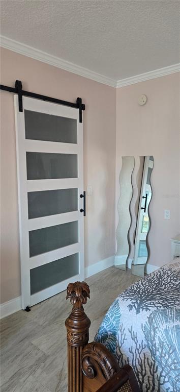 538 Crystal Drive Madeira Beach, FL 33708 - Photo 16 of 21 a bedroom with a bed and wooden floor