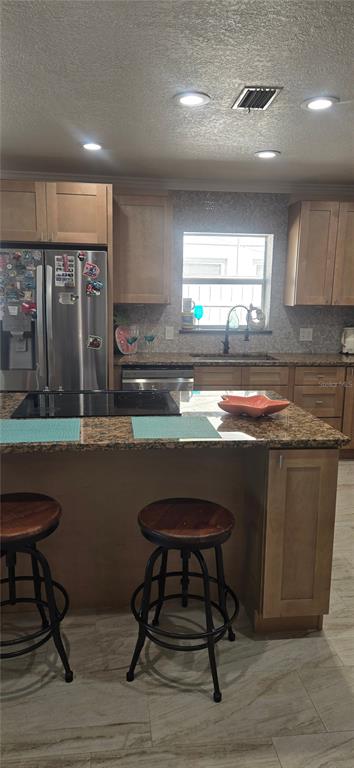538 Crystal Drive Madeira Beach, FL 33708 - Photo 8 of 21 a kitchen with stainless steel appliances granite countertop a table chairs sink and cabinets