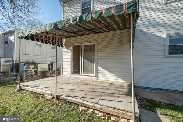 a view of a house with a small yard and wooden floor and fence