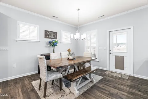 a kitchen with a sink stove and wooden floor