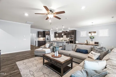 a living room with furniture and wooden floor