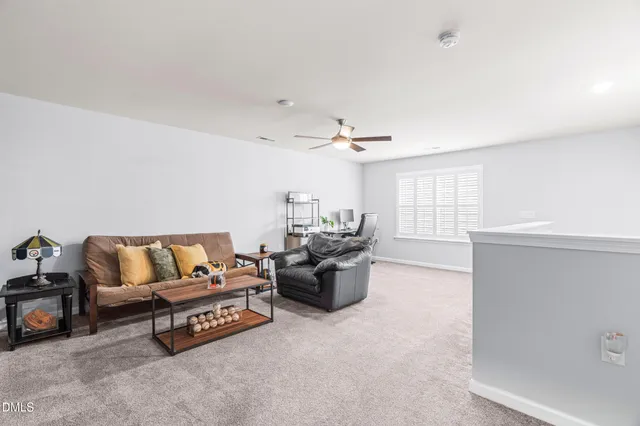 a living room with stainless steel appliances kitchen island granite countertop a refrigerator a stove a sink with a dining table and chairs