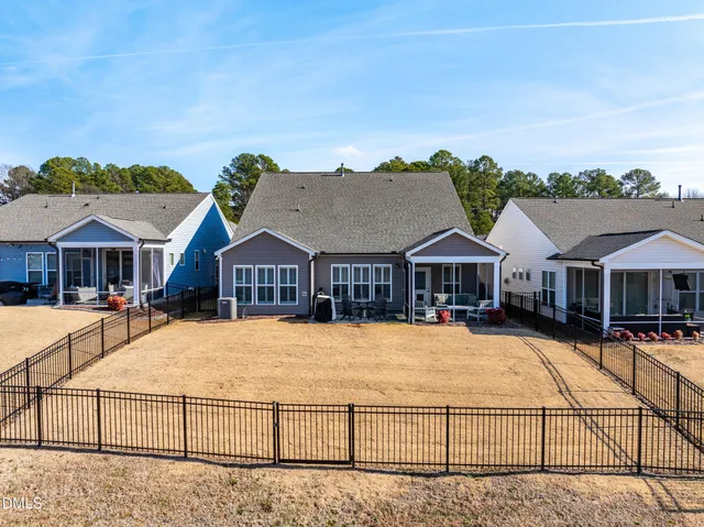 a view of a house with wooden fence