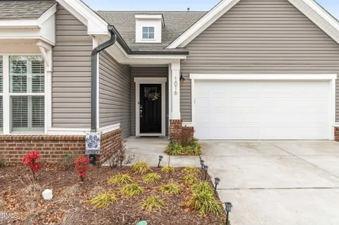 a view of a house with a yard and garage