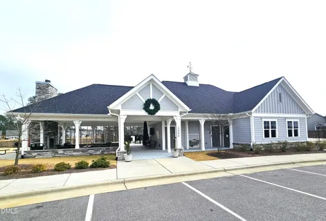 a view of a house with a large windows and a yard